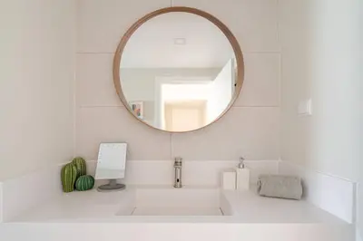 a bathroom with a sink and a mirror at Casa Eden 2BR modern Apartment near Marina! Patio-Porch-WS-BBQ-FAST WIFI! in Quarteira