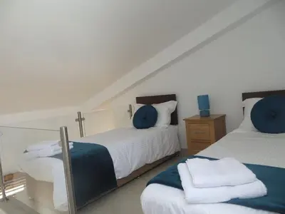 a bedroom with two beds with blue pillows at Luxury Villa with Private pool walking distance to beach and Marina in Quarteira