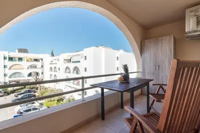a balcony with a table and chairs and a view at BnB Homes Apartments near Ocean & Lush Nature 500 m away from the ocean in Guia