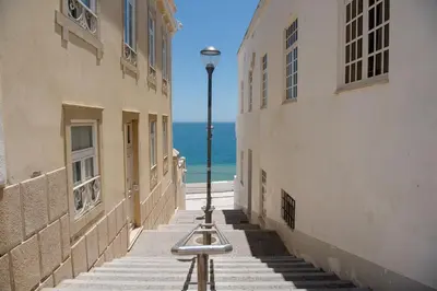 a street in positano with a blue and white building at BnB Homes Apartments near Ocean & Lush Nature 500 m away from the ocean in Guia