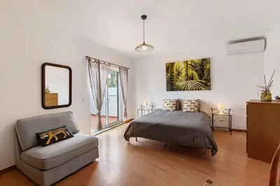 a bedroom with two beds and a desk at Al´Corais in Albufeira
