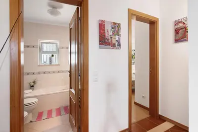 a staircase in a living room with two chairs at Al´Corais in Albufeira