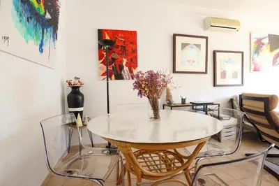 a dining room with a glass table and chairs at Jardins do Castelo - Piscina e tranquilidade - BY BEDZY in Albufeira