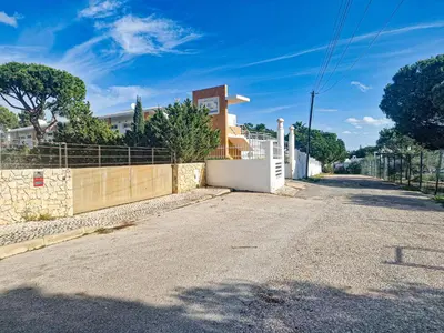 an empty street with a fence on the side at Jardins do Castelo - Piscina e tranquilidade - BY BEDZY in Albufeira