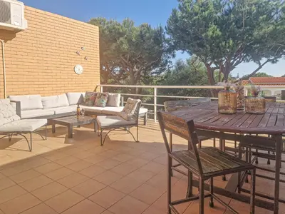 a patio with a table and chairs and a couch at Jardins do Castelo - Piscina e tranquilidade - BY BEDZY in Albufeira