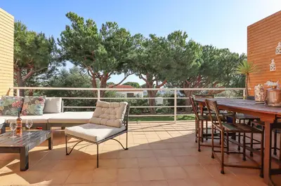 a patio with a couch and a table and chairs at Jardins do Castelo - Piscina e tranquilidade - BY BEDZY in Albufeira