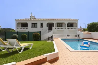 a house with a pool and a toy in the yard at Vila de Santa EulAlia III - Albufeira in Albufeira