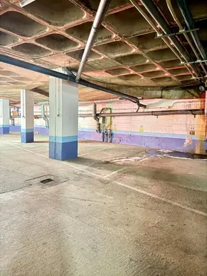an empty parking garage with a bike parked in it at Home Out Albufeira - T1 Oura in Albufeira