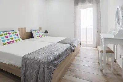 a bedroom with a bed and a table and a desk at Vista Azul - 500 from the beach - AC - BY BEDZY in Albufeira