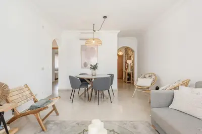 a living room with a table and chairs at Praia Village II - Peaceful condominium by HD in Vilamoura