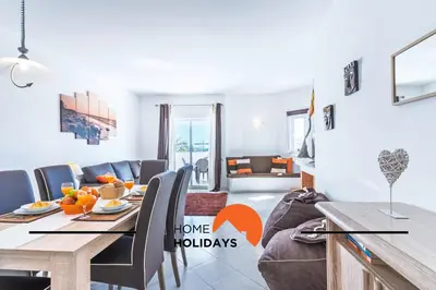 a dining room with a table and a couch at #314 T2 Serenity by Home Holidays in Albufeira