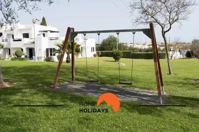 a swing set in the yard of a house at #314 T2 Serenity by Home Holidays in Albufeira