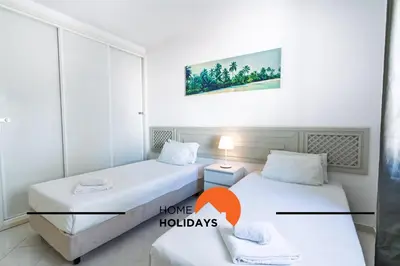 two beds in a room with a picture of a bedroom at #314 T2 Serenity by Home Holidays in Albufeira