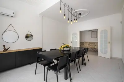 a dining room with a black table and black chairs at Villa Sitambo- Pool & Sea View in Albufeira