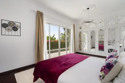 a bedroom with a large bed and a window at Villa Sitambo- Pool & Sea View in Albufeira