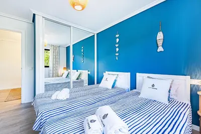 two beds in a room with blue walls at Apartamento T3 Praia da Falésia - PINE SUN PARK in Albufeira
