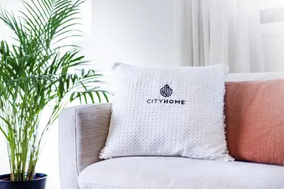 a pillow with the chiryu logo on it sitting on a couch at Apartamento T3 Praia da Falésia - PINE SUN PARK in Albufeira