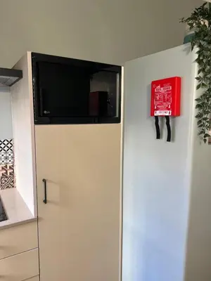 a white refrigerator with a tv on top of it at casa da vila 33 in Faro