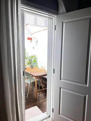an open door to a dining room with a table at casa da vila 33 in Faro