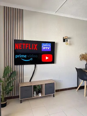 a television on a wall in a living room at Albufeira Cozy Sea View with Balcony & Resort Access in Albufeira