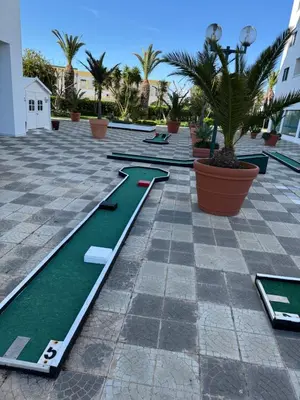 a row of mini golf courses on a patio at Albufeira Cozy Sea View with Balcony & Resort Access in Albufeira