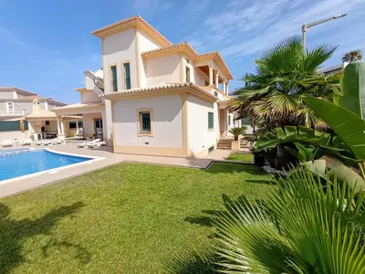 a villa with a swimming pool and a house at Villa Ocean Gale in Albufeira