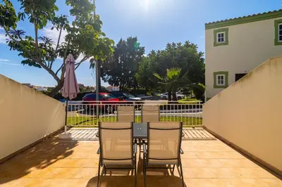 a swimming pool in a resort with palm trees at Ponta Grande Resort - Villa Maré in Albufeira