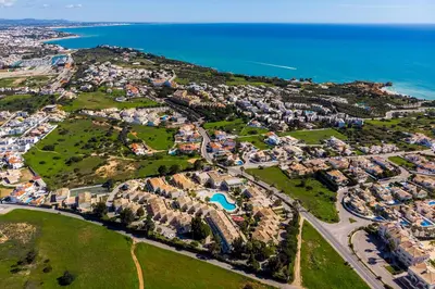 a hotel room with two beds and a window at Ponta Grande Resort - Villa Maré in Albufeira