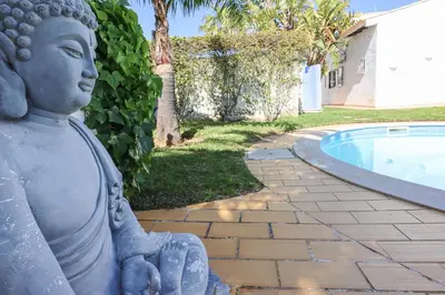 a statue sitting next to a swimming pool at 2 Vale de Ursa - Swimming Pool - WIFI - BY BEDZY in Guia