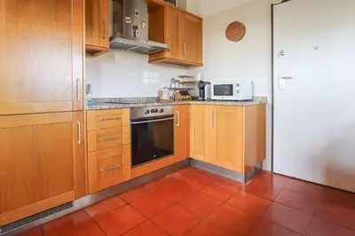 a kitchen with wooden cabinets and a stove top oven at 2 Vale de Ursa - Swimming Pool - WIFI - BY BEDZY in Guia