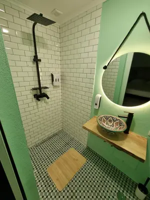 a bathroom with a sink and a mirror and a counter at Wonder Charm Guesthouse in Albufeira