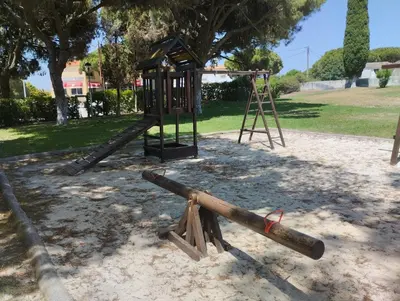 a playground with a swing set in a park at Açoteias Secrets in Albufeira