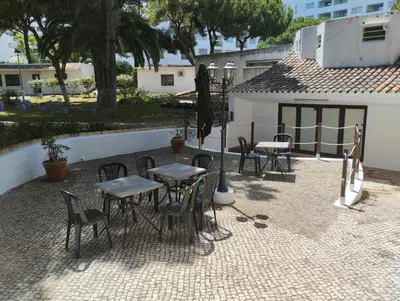 a group of tables and chairs in a patio at Açoteias Secrets in Albufeira