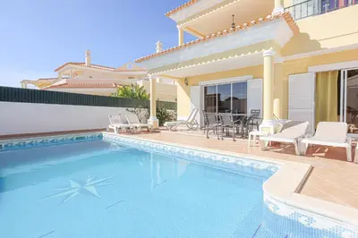 a villa with a swimming pool and a house at Villa Tio Pedro - Swimming Pool - For families- BY BEDZY in Albufeira