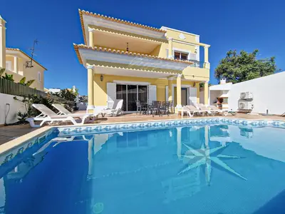 a villa with a swimming pool in front of a house at Villa Tio Pedro - Swimming Pool - For families- BY BEDZY in Albufeira