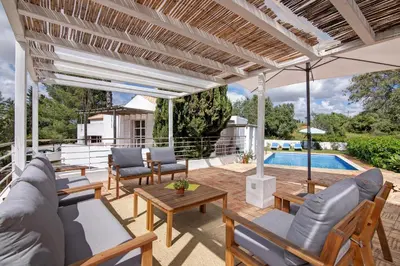 an outdoor patio with furniture and a swimming pool at Casa do Pateo in Guia