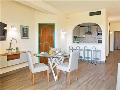 a dining room and kitchen with a table and chairs at Amazing ApartHotel Apartments 2 Bedroom in Albufeira in Albufeira