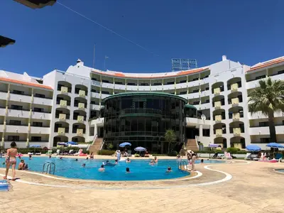 a swimming pool in front of a large building at Amazing ApartHotel Apartments 2 Bedroom in Albufeira in Albufeira