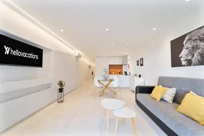 a living room with a couch and a table at Saro Apartment by HelloVacations in Albufeira