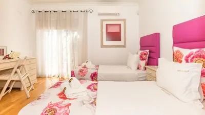 two beds in a room with pink and white at Vilamoura - VILLA LIMONI in Vilamoura