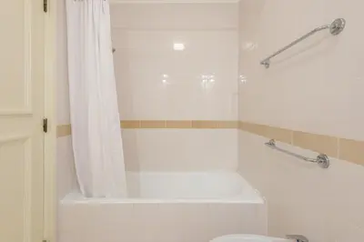a bathroom with a tub and a toilet and a shower at Jardins do Golfe at Vale do Lobo in Vale do Lobo