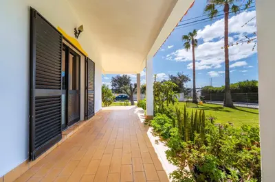 a walkway outside of a house with palm trees at Villa 4 Quartos, Piscina, AC, Jardim, Prestige For Home in Loulé