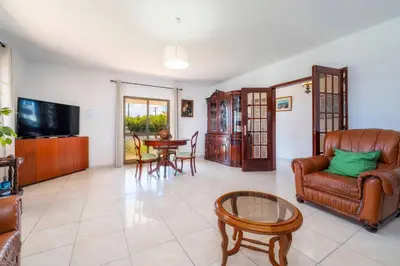 a living room with a couch and a table at Villa 4 Quartos, Piscina, AC, Jardim, Prestige For Home in Loulé