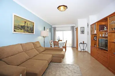 a living room with a couch and a tv at A32 - Lancemar Flat in Albufeira in Albufeira