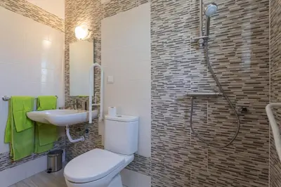a bathroom with a toilet and a sink and a shower at Toiago in Vilamoura