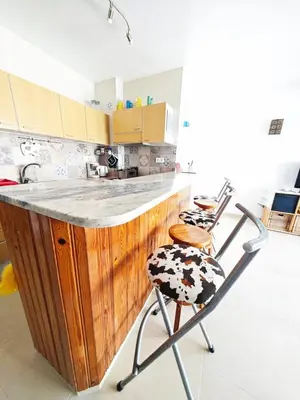 a kitchen with a wooden counter and two chairs at Blife Paulya private apartment in Faro