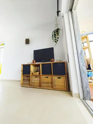 a living room with a television on a wooden cabinet at Blife Paulya private apartment in Faro