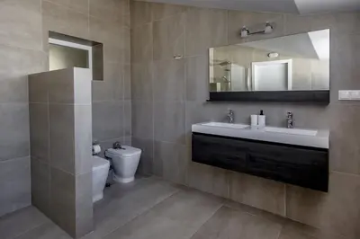 a bathroom with a sink and a toilet and a mirror at Beautiful Villa with a Pool in Albufeira