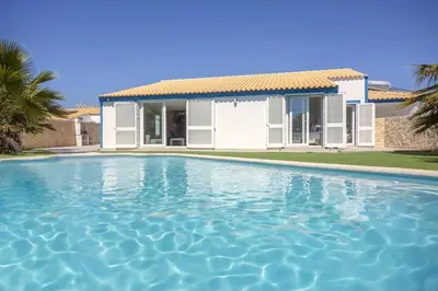 a villa with a swimming pool in front of a house at Beautiful Villa with a Pool in Albufeira