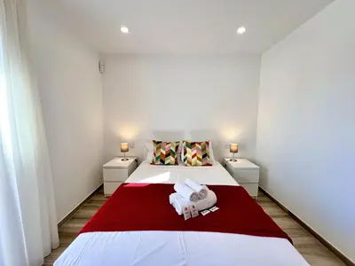 a bedroom with a bed with towels on it at Vilamoura Design 2 by Homing in Vilamoura